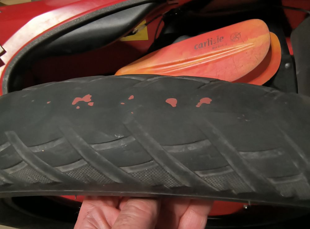 A photo of a bald bicycle tire with belts showing.