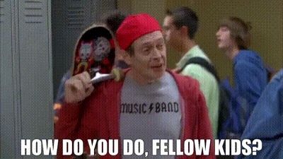 Steve Buscemi dressed-up as an archetypal/caricatural teenager, with backwards cap, skateboard over the shoulder and a T-shirt that reads "music band" saying "how do you do, fellow kids?" in a poor attempt to blend in