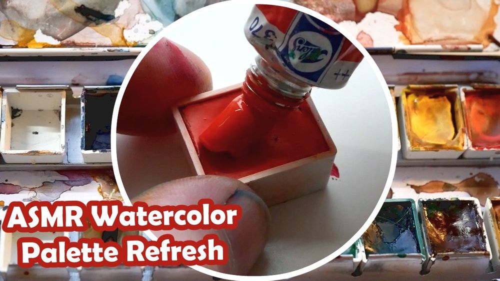 A youtube thumbnail. The background is a close up photo of a very messy watercolor palette with lots of different colors. In the center, there's a circle with an even closer up shot of a single red watercolor pan getting fresh paint squeezed into it. The text reads: "ASMR Watercolor Palette Refresh."