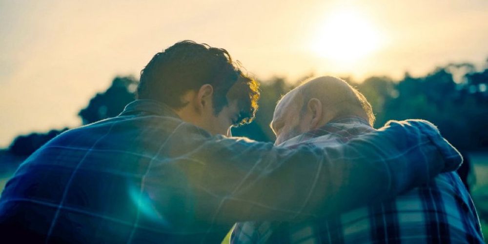 Clark Kent with his arm around his dad