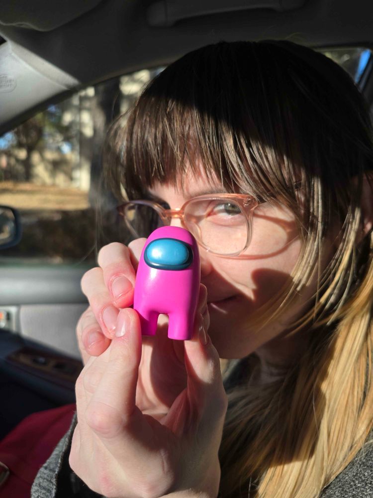 me holding pink among us blind box figurine up to my face