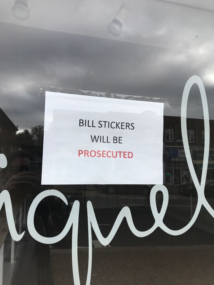 A sign that reads “BILL STICKERS WILL BE PROSECUTED”
