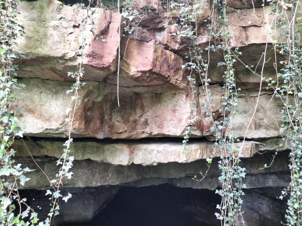 A cave entrance with an obvious loose rock in the roof.