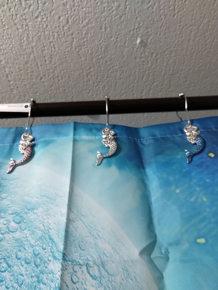 Three mermaid shower curtain holders, in pink silver and blue
