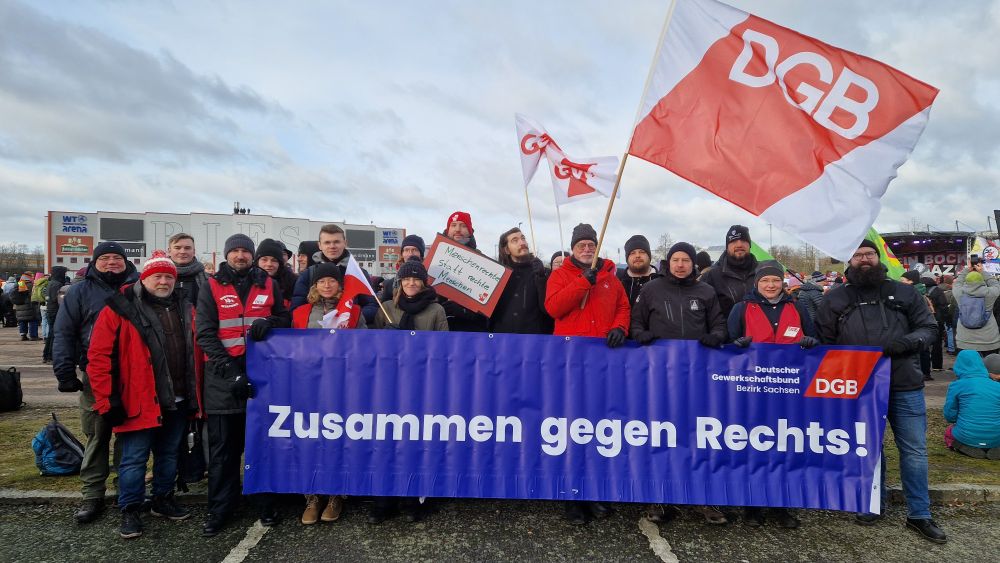 Zu sehen ist eine Gruppe von Menschen mit einem Banner und DGB-Fahne. Auf dem Banner steht: Zusammen gegen Rechts!