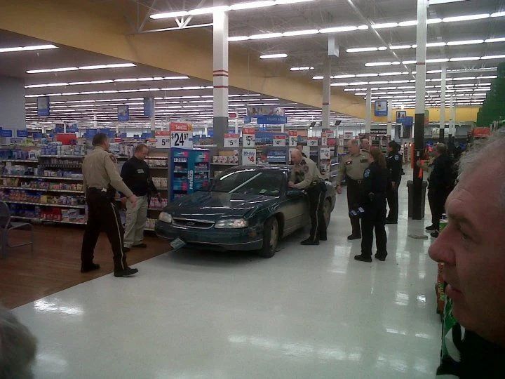 Car parked in a Walmart aisle.