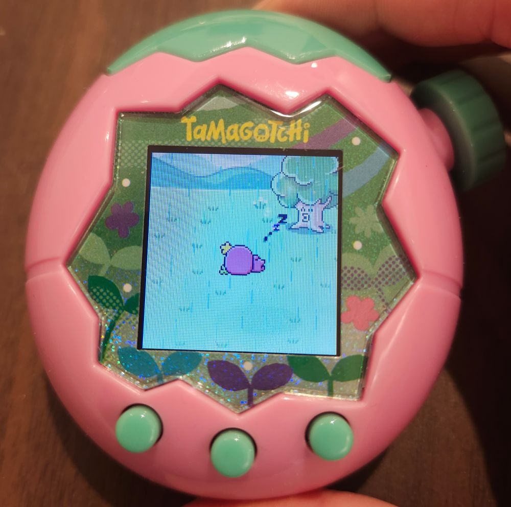 A pink land tamagotchi paradise with a sleeping furawatchi