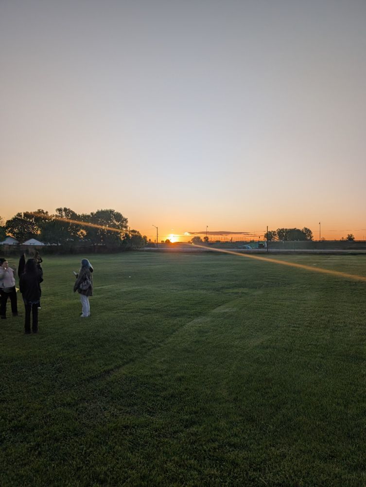 The sun rising just at the horizon 