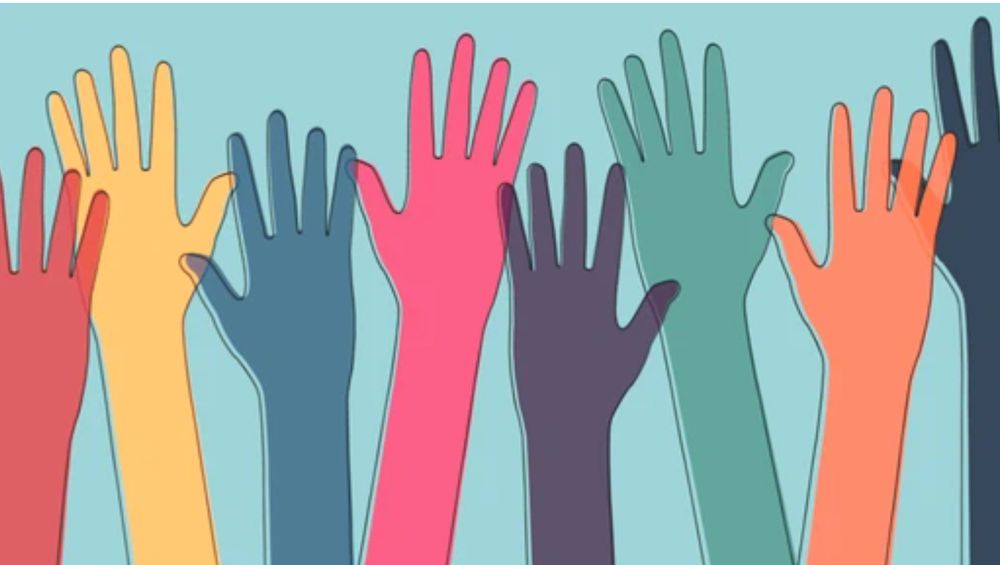 Illustration of diverse, colourful hands raised against a light blue background.