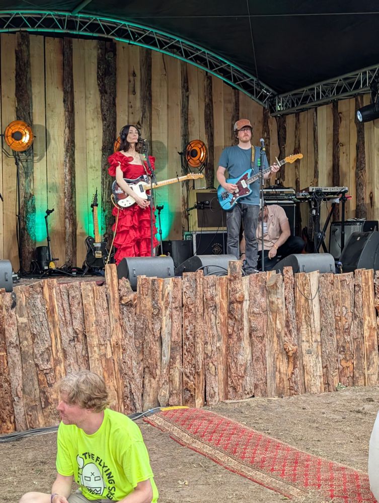 the band King Hannah setting up on stage, including Craig and Hannah standing up front with guitars
