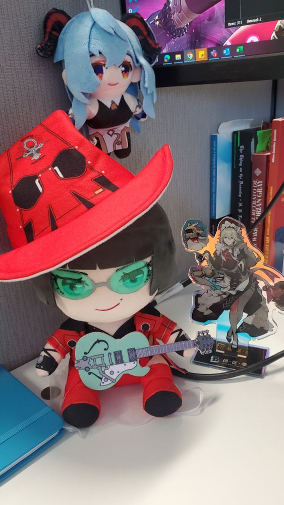 My desk at work got a plushie of I-No, another one of Ganyu, and an acrylic standee of Rina all looking cute in the corner