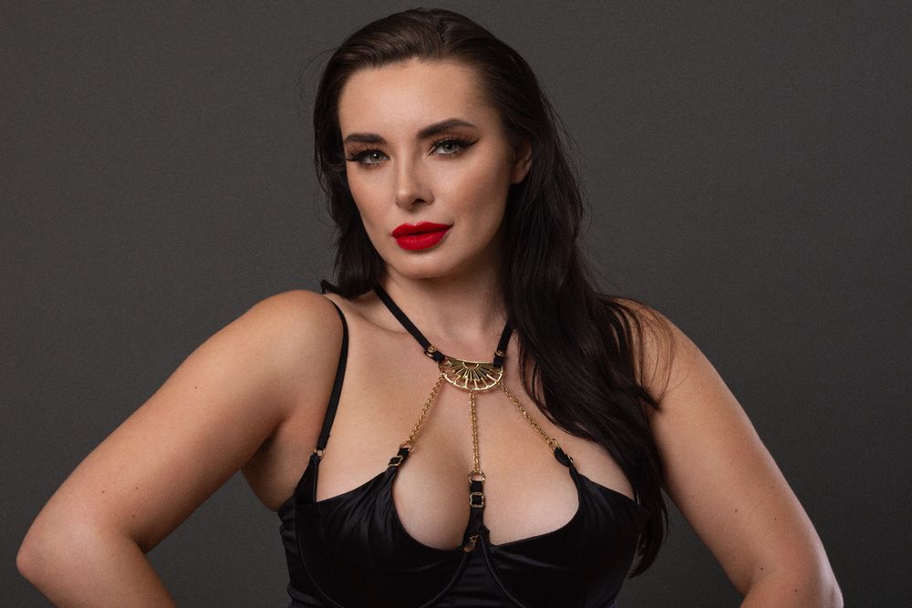 Valis Volkova poses in an evening dress in a studio portrait.