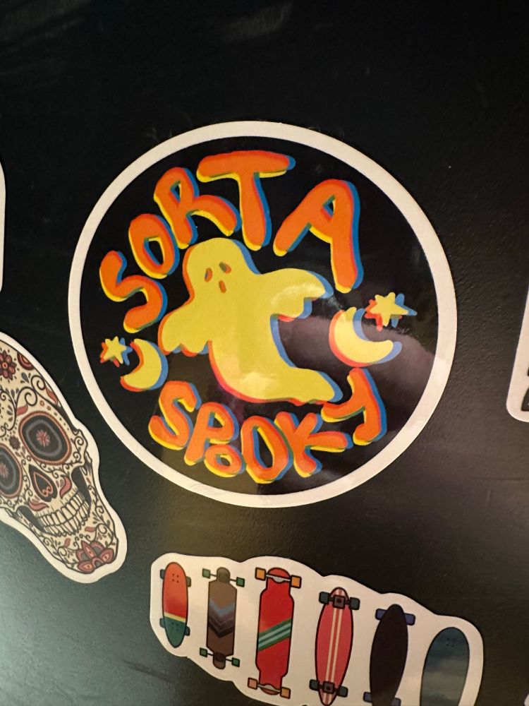 Sticker with a ghost and some stars n' moons that says 'Sorta spooky'