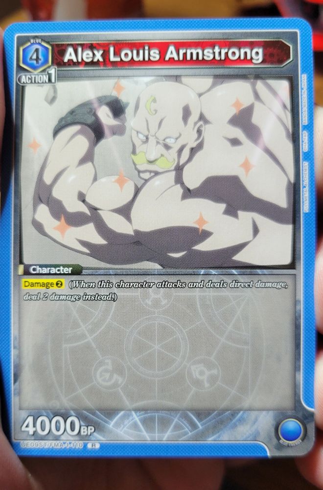 The (an?) Alex Louis Armstrong character card for Union Arena. Is blue, requires 4 energy and 1 action, has 4000 BP and the keyword Damage 2, or can provide 1 blue energy. At least I think that's a cogent description of the card based on skimming the rule sheet?