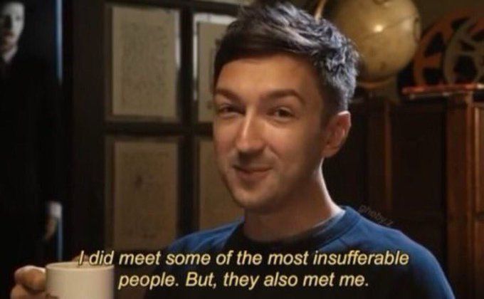 Screen grab of Shane Madej from Buzzfeed Unsolved days, holding a white coffee cup. Captions over the image say “I did meet some of the most insufferable people. But, they also met me.”