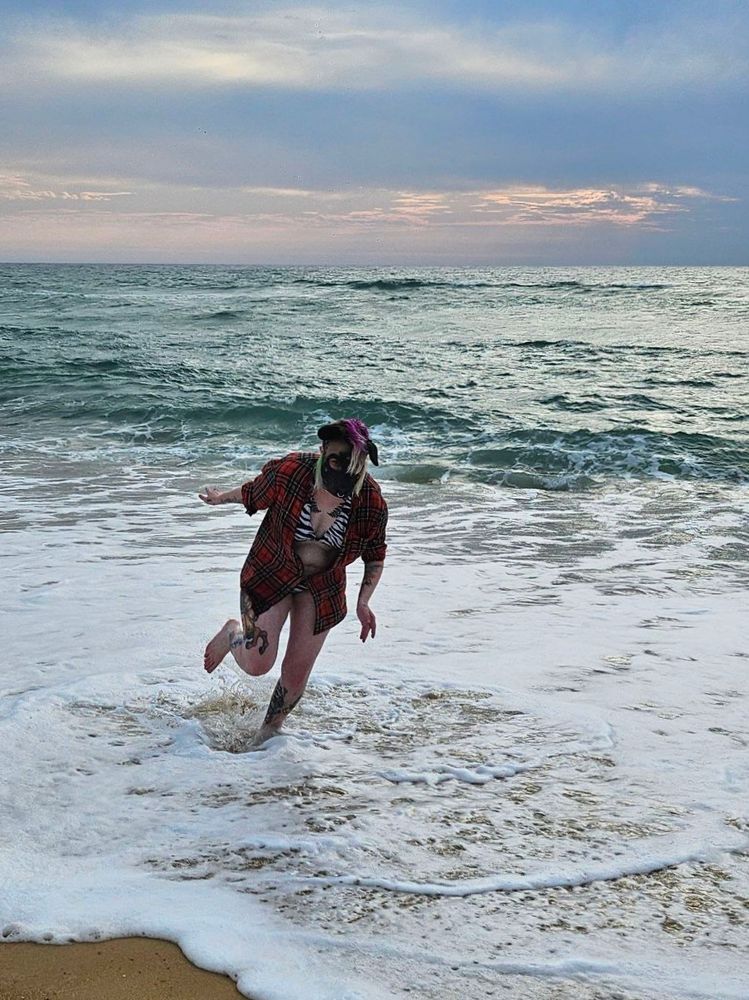 Mlice wearing their Hyena hood and running in the sea