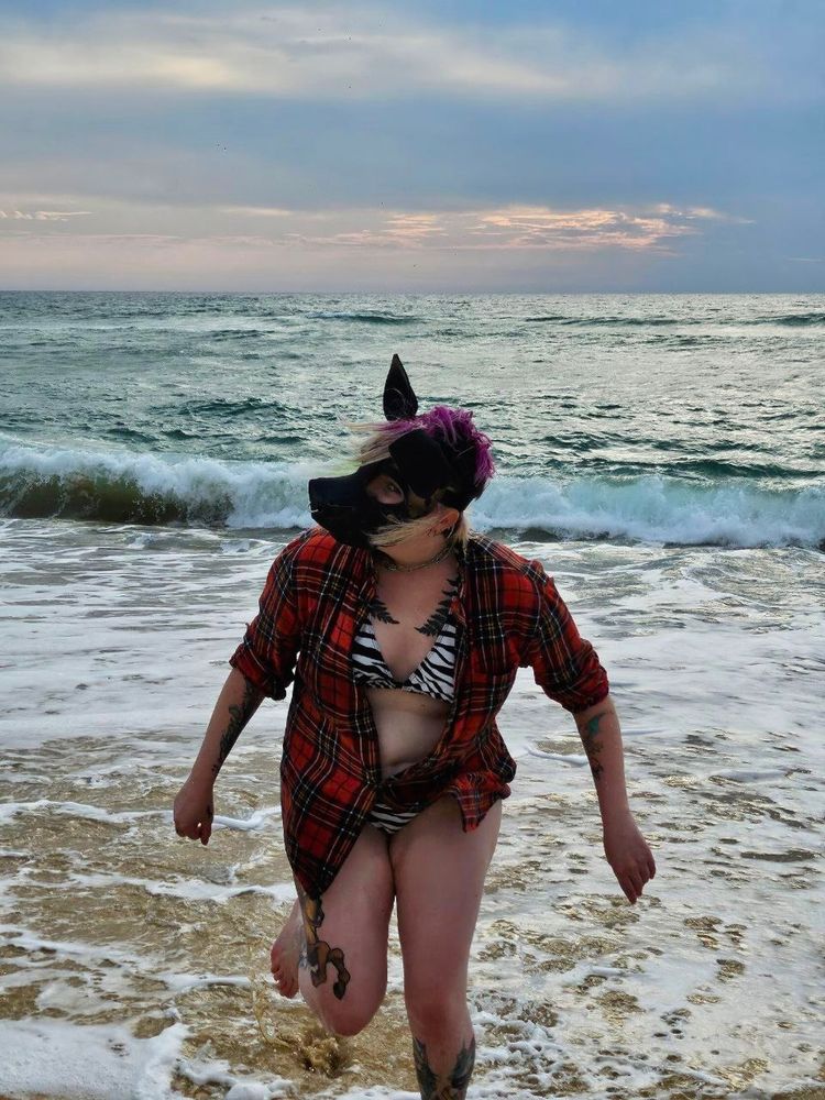 Mlice wearing their Hyena hood and running in the sea