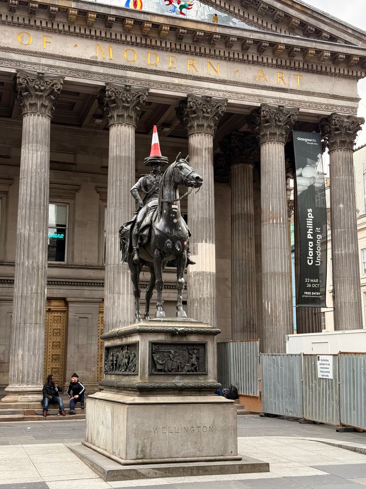 Wellington's statue, adorned with a traffic cone (actually three) outside the Gallery of Modern Art. 