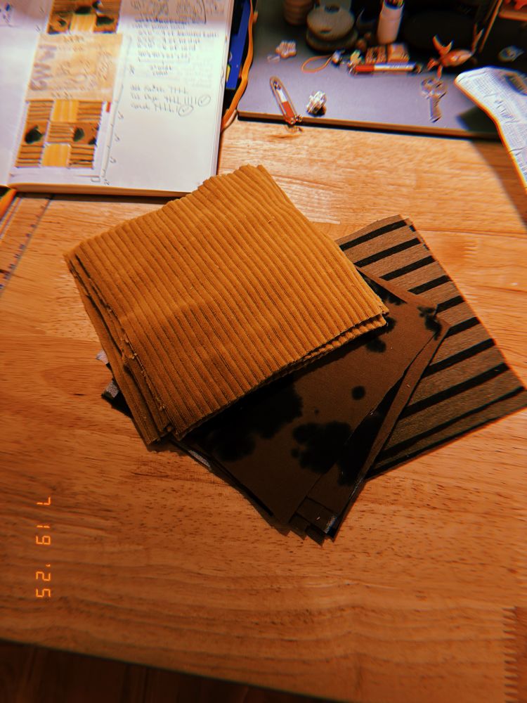 mmmm a pile of freshly pressed fabric squares. yellow corduroy, brown & black tie-dyed cotton, and beige & black striped jersey.