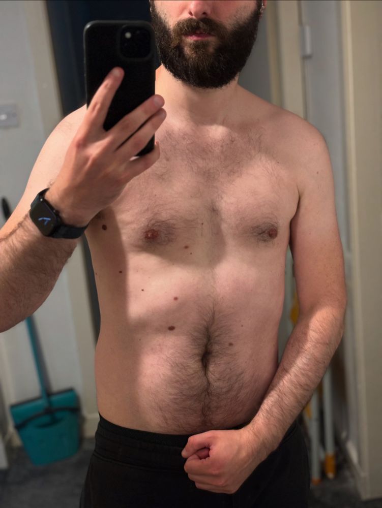 Me flexing in mirror after working out with a classic shirtless pose. Positive gym session too