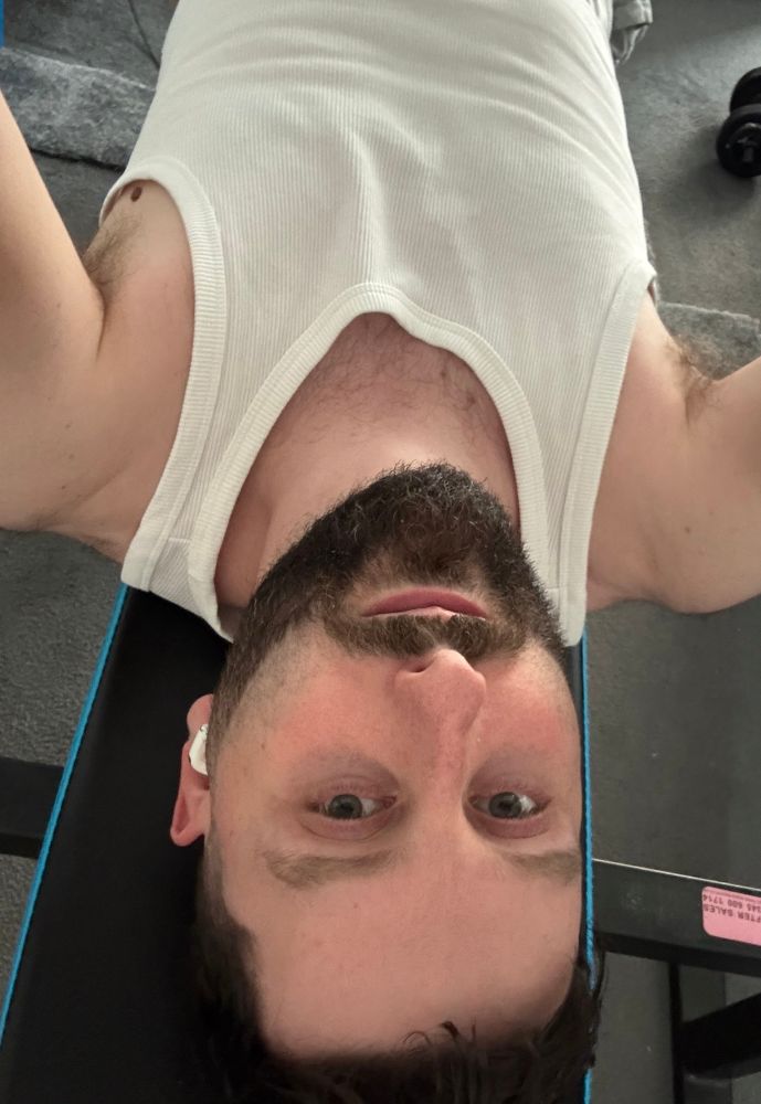 Me laying on an exercise bench. I appear upside down from the camera perspective. 