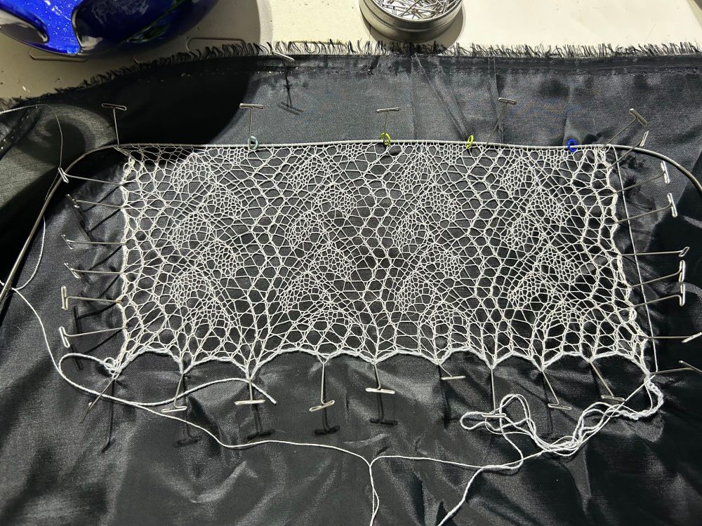 Lace knitting which is the start of a wedding veil. 