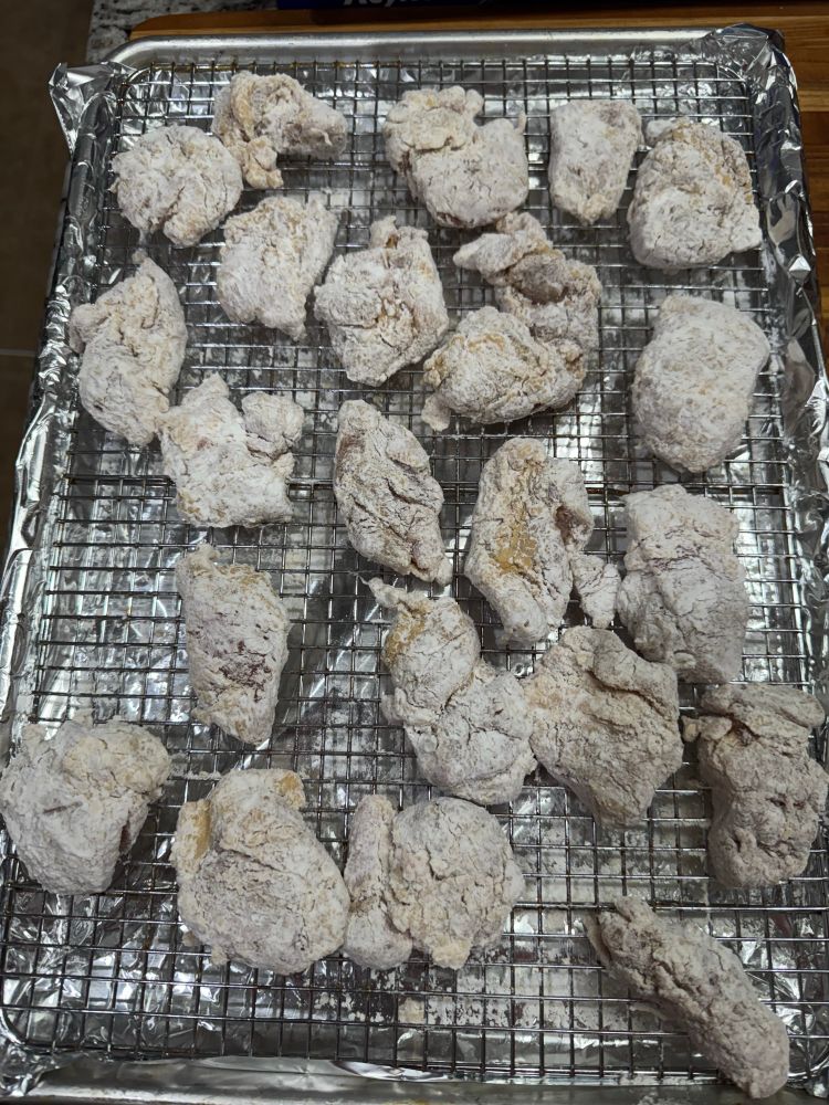 Chicken coated in potato starch waiting to be fried