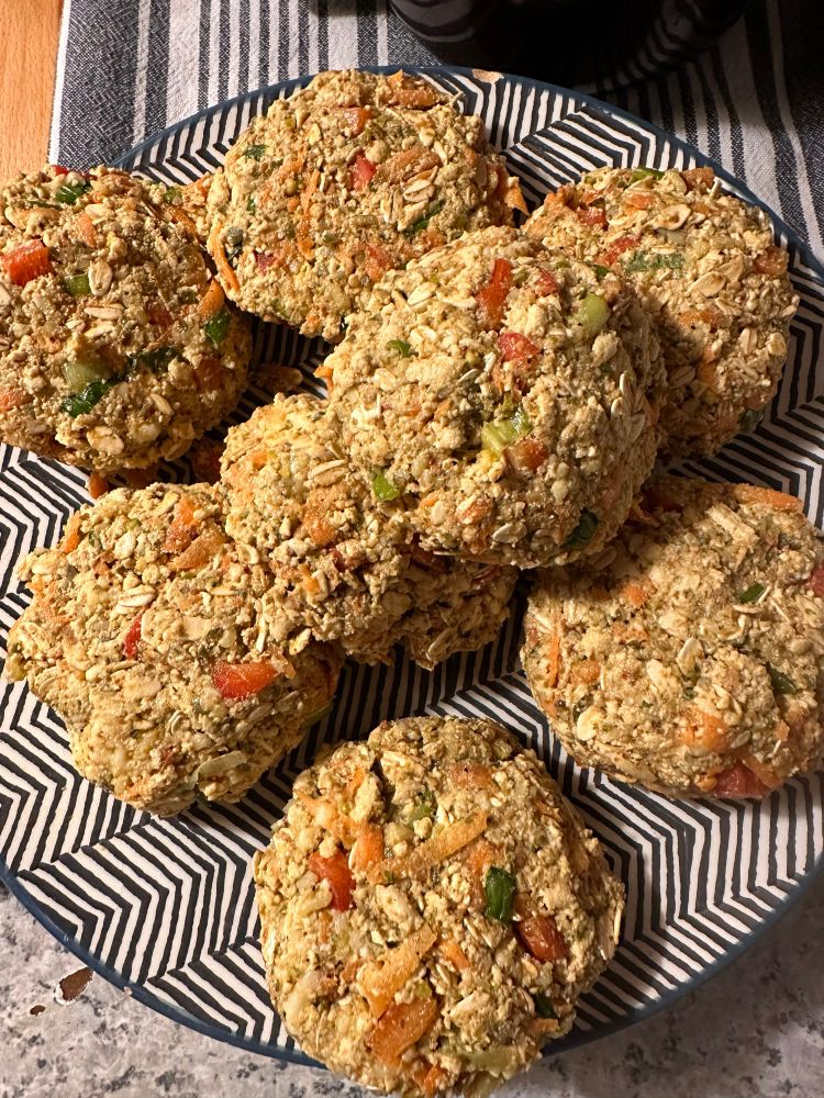 Tofu burgers pre cooking on a a herringbone patterned blue and white striped plate You can see ostmeal, red peppers, grated carrot, green onions , grated cheese There is egg, miso,nutritional yeast, salt and pepper Tajine spice I fry them and they are fantastic A recipe I learned in the summer of 2000 when I had felt so hurt but came out fighting and won I did meet someone, get married, have children , feel very hurt again but much more minded to leave the past and do what needed to be done Twenty five years later and the burgers taste better as I traffic the recipe and my life Cooking is a reflection as well as a look at the sky moment 