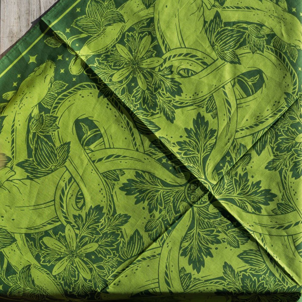 a closeup of a green bandana with eels and aquatic plants printed on it