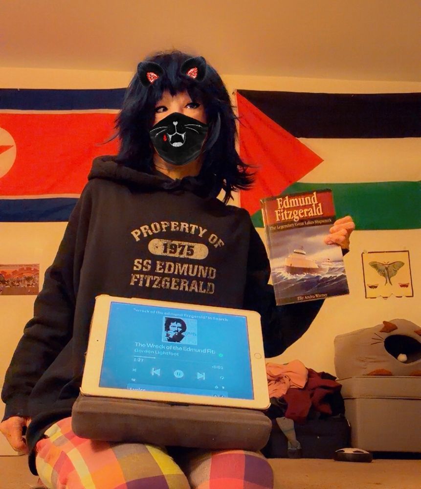 Me in my Fitz hoodie listening to the Gordon Lightfoot song & holding up my emotional support Edmund Fitzgerald book