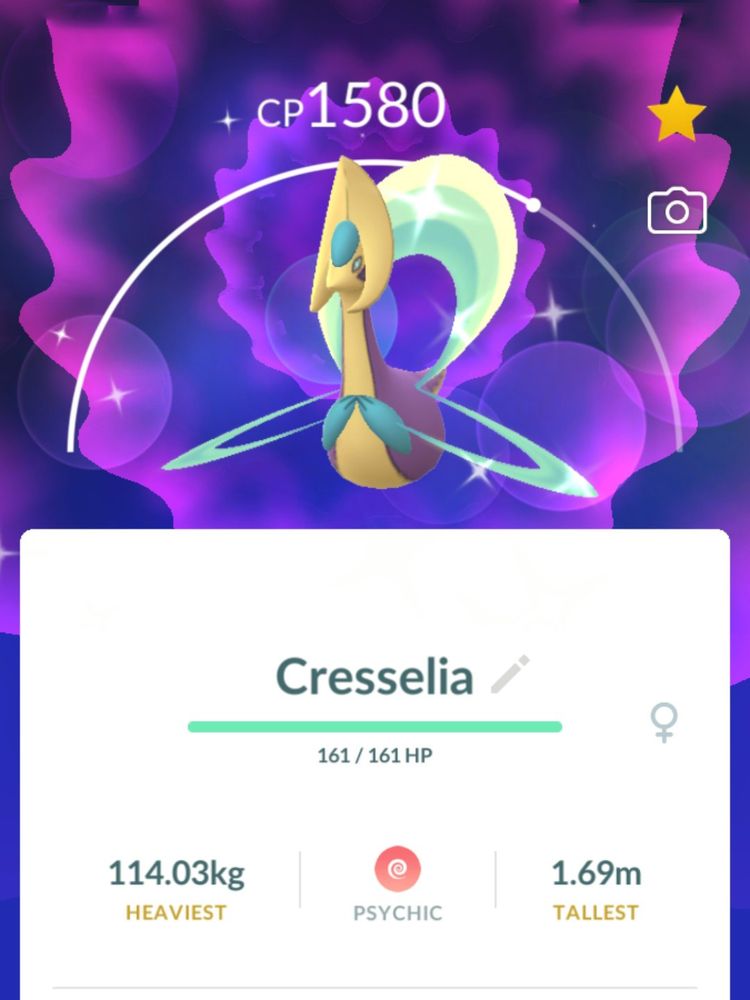 Screencap of a shiny Cresselia from Pokemon GO. A mythical Pokemon with a swan-like body and crescent-shaped wings. Sparkles surround it.