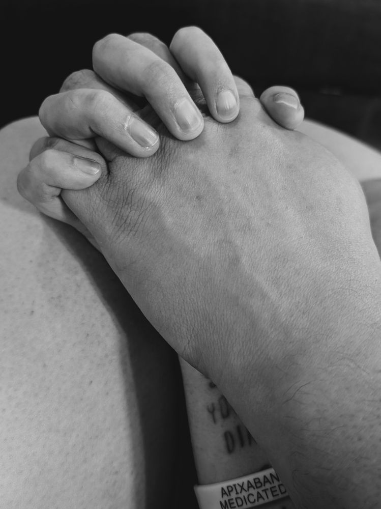 Black and white photo of my partner's hand in mine.