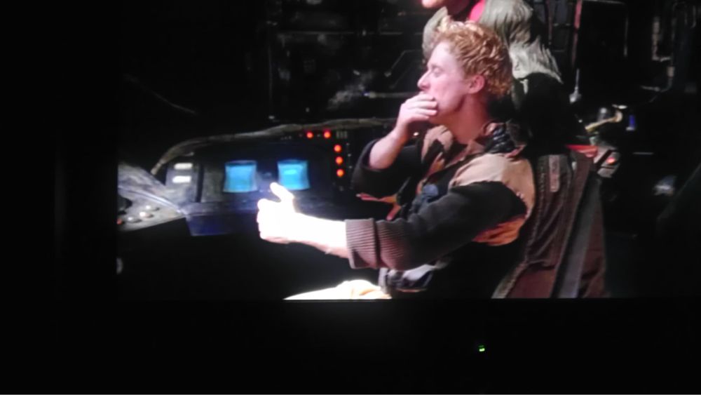 A screenshot from Firefly episode 1. Looking sideways at the cockpit. Wash’s hands are out as if he’s holding a steering wheel, but there is no steering wheel actually there.