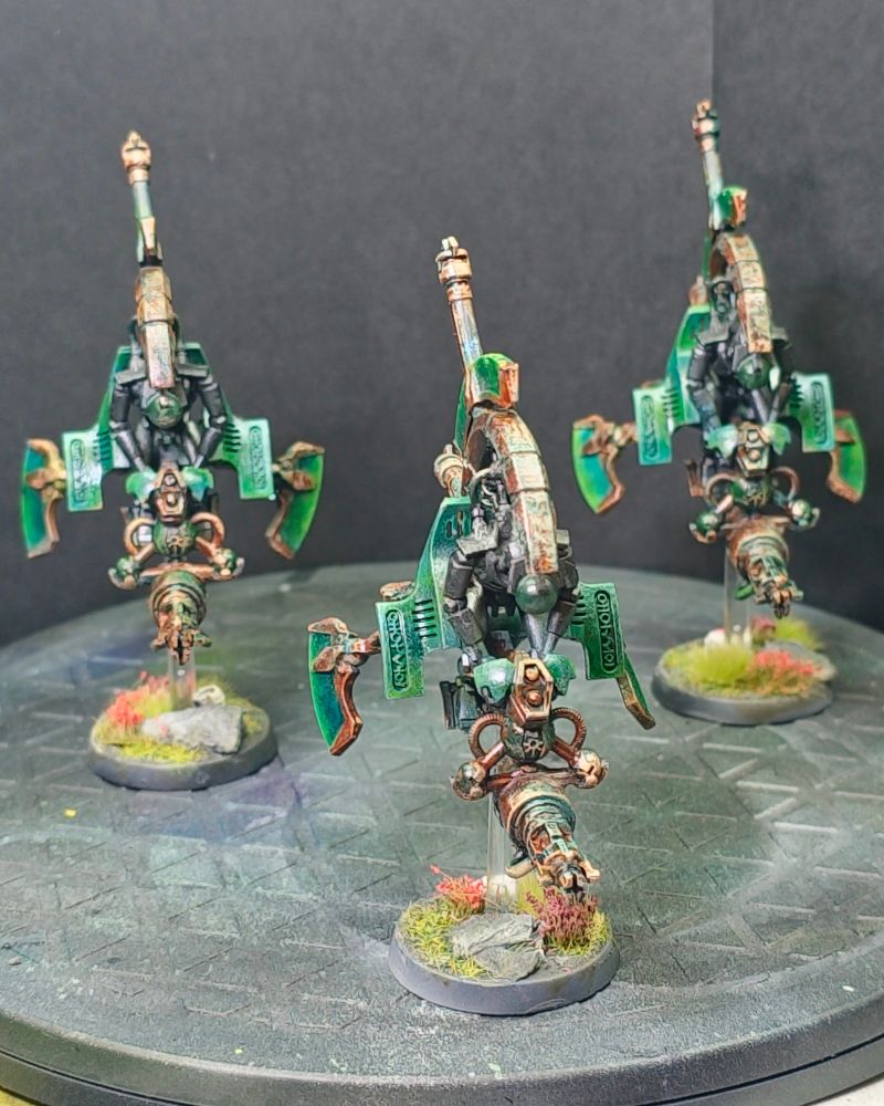 Three miniture models of necron speeder bikes called "Tomb Blades"