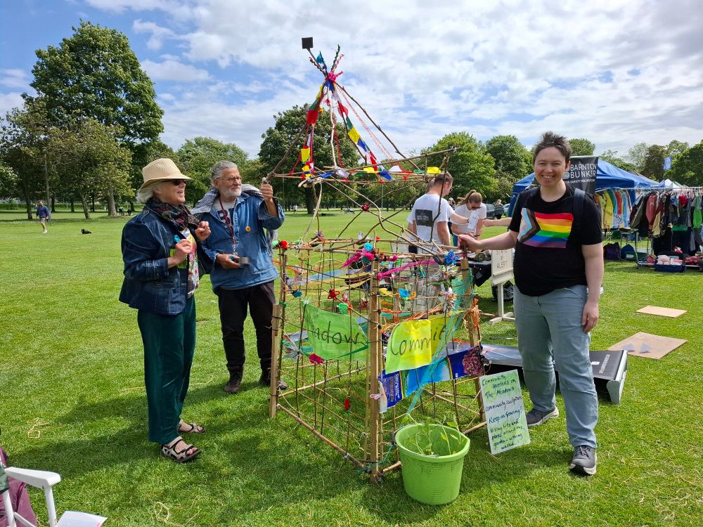 Pauline (to the right) with the Meadows Community Garden volunteers and their sculpture framework pyramid tower