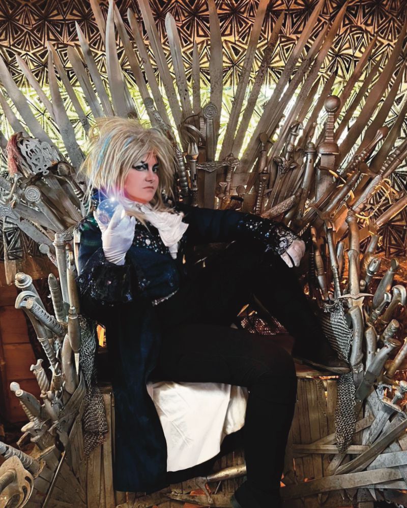 My Jareth the Goblin King from Labyrinth cosplay, seated on the iron throne