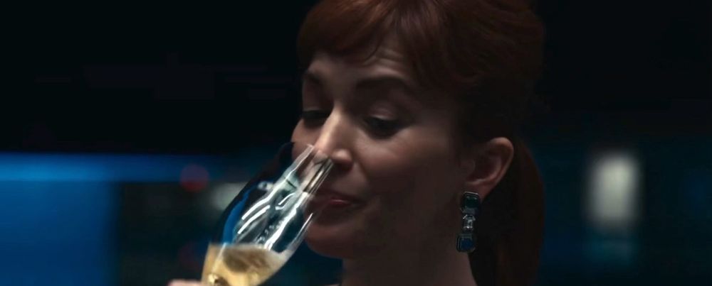 Unbothered taking a sip of champagne 
