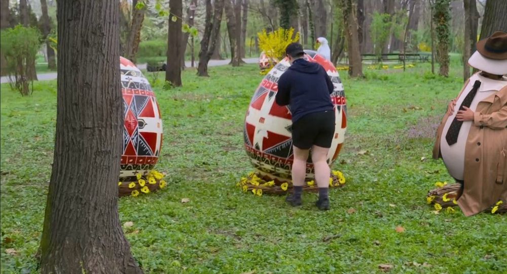 Vince the Egg sitting near Izzy while she hunts for eggs