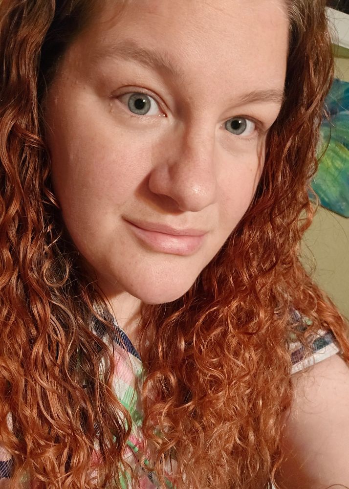 Middle aged woman, blue eyes, long curly red hair