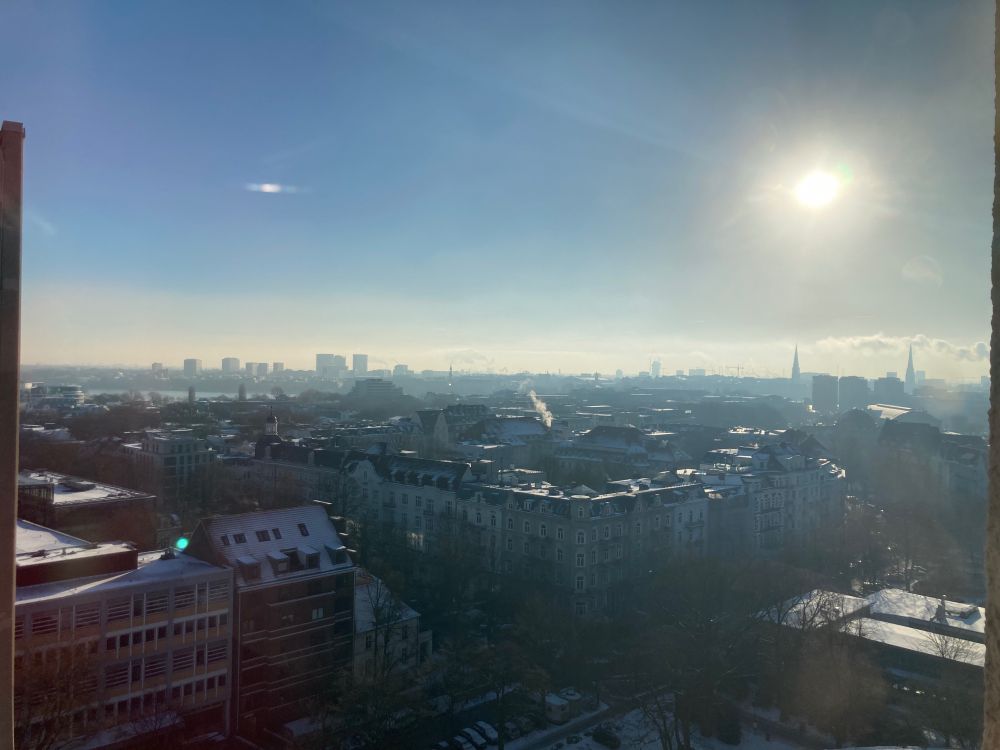 View from a high building across the city in sunlight.