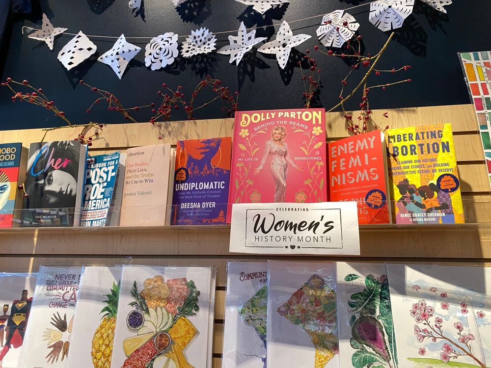 A display of books- Cher, Post-Roe America, Our Bodies Their Lies and the Truths We Use to Win, au diplomatic, Dolly Parton Behind the Seams, Enemy Feminisms, Liberating Abortion 