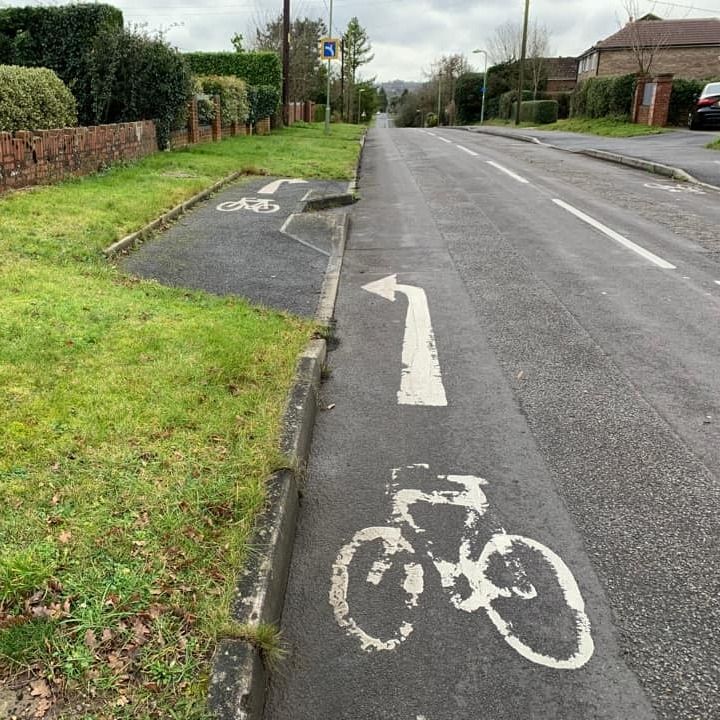 A horrible UK bike lane. It doesn't even have a solid painted line.
