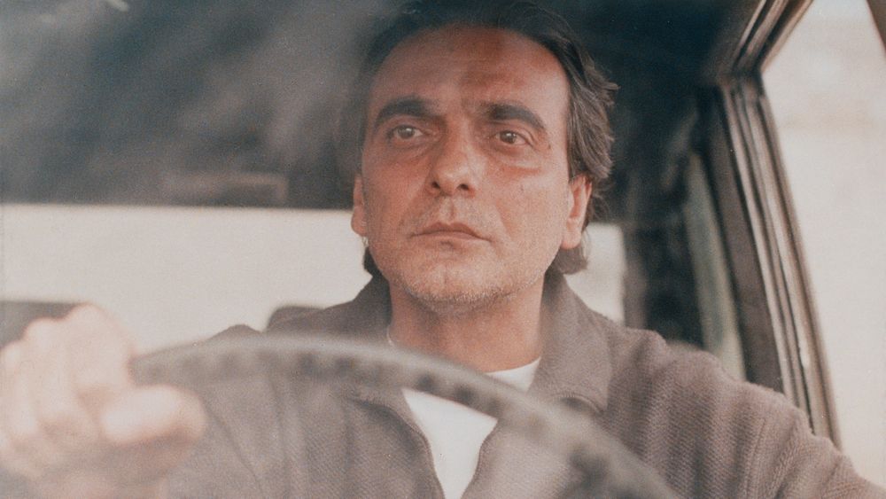 A man driving a car in the film A Taste of Cherry