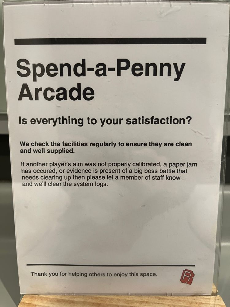 A sign in a lavatory with computer and video game scatological puns