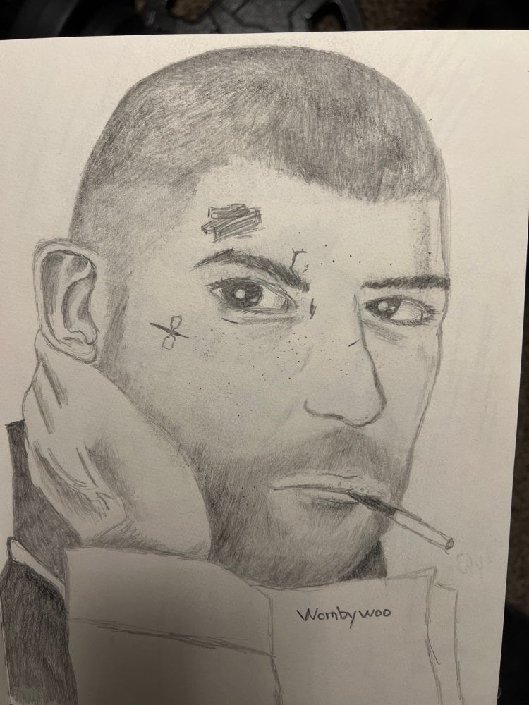 A pencil drawing of a reference of an original artwork featuring Quinn, an original character created by artist extraordinaire Wombywoo- a man with a buzz cut, five o clock shadow, and a cigarette with his right hand holding the side of his neck while looking at the camera.