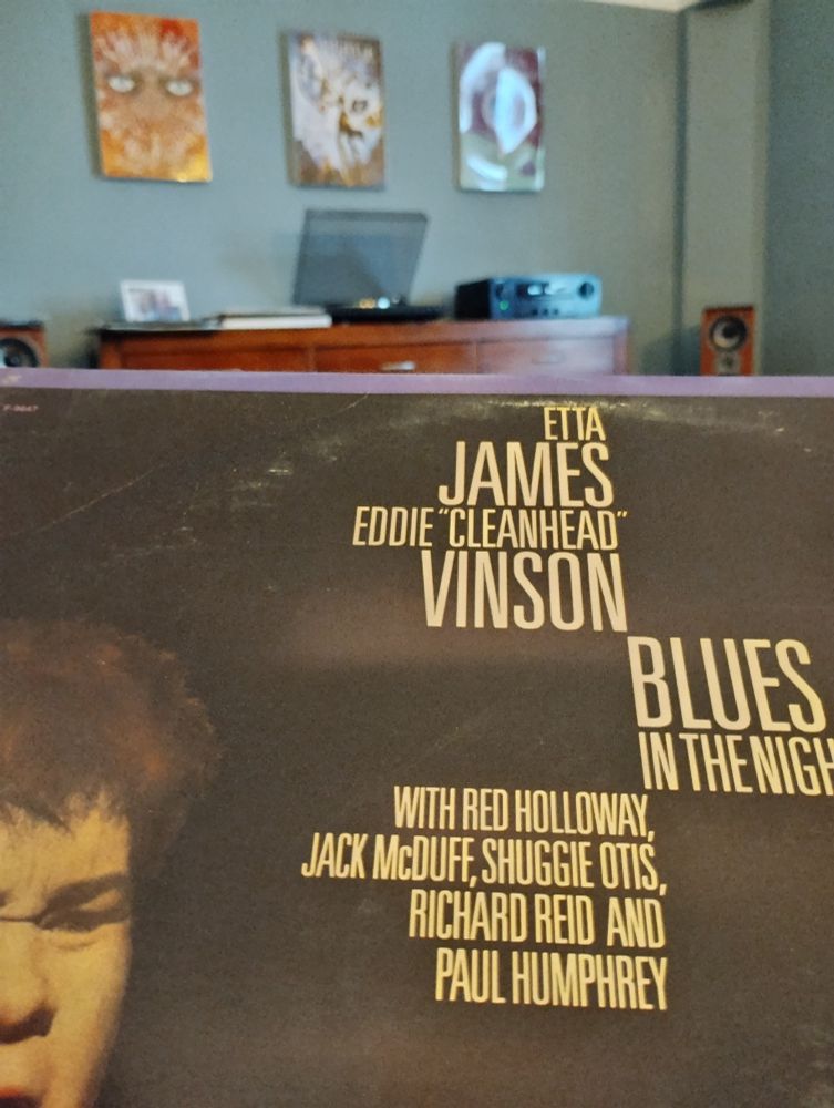 Record cover of Etta James's blues in the night in front of a record player. 