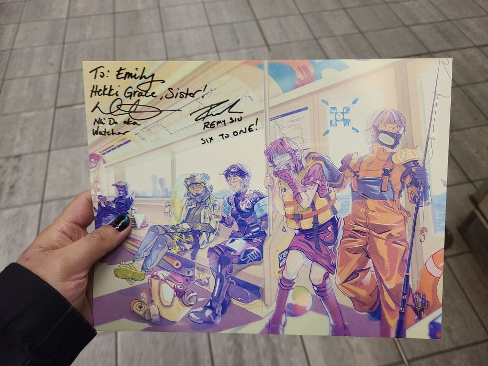 photo of a print of part of the cast of the game 1000xResist. the print is signed by Remy Siu and Nhi Do