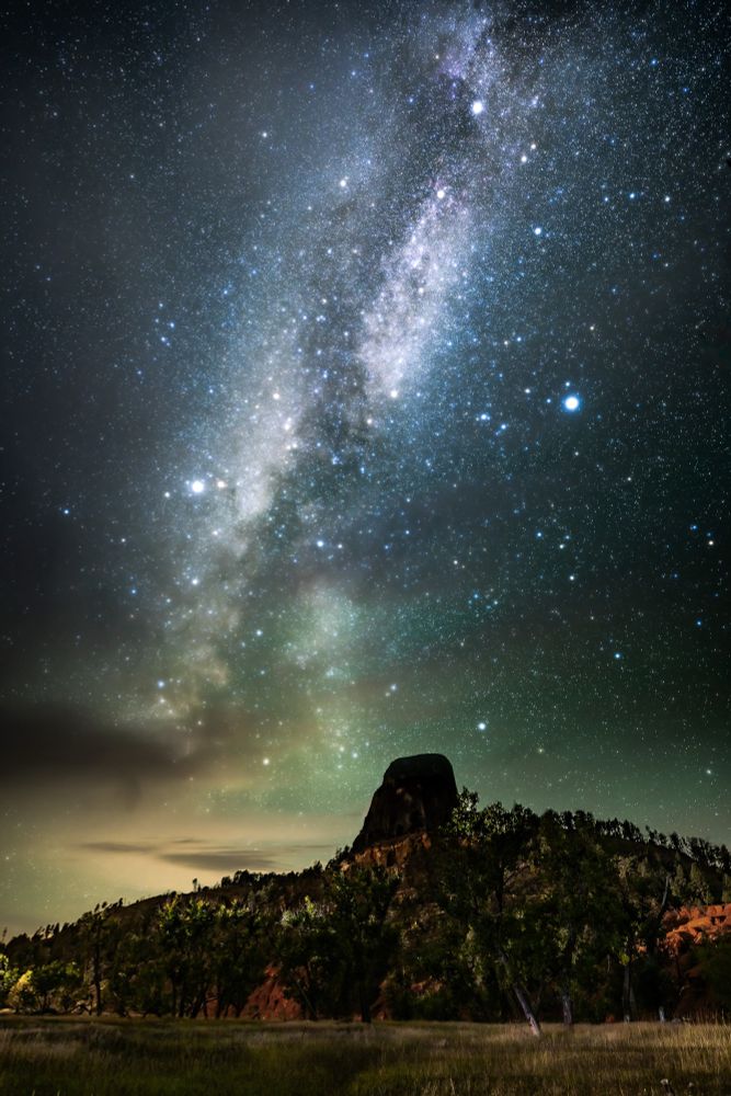A picture of the Milky Way in a starry sky above Devil’s Tower in Wyoming.