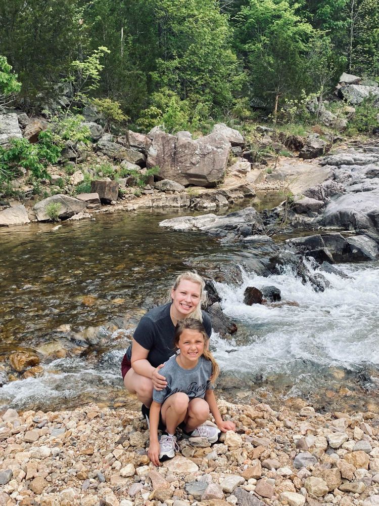 Proud momma and daughter posing on the rocks 