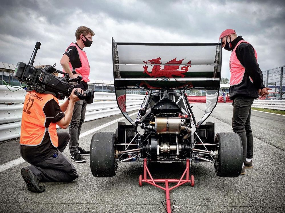Formula Student; a car getting ready to leave with our cameraman Ross on hand with a Sony Z450 with a Gigawave Antenna broadcasting it back to our truck